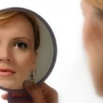 woman looking in mirror