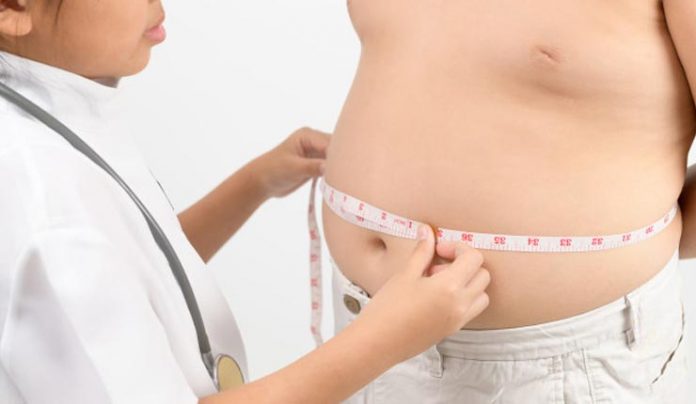 doctor-measuring-obese-child-waist-body-fat